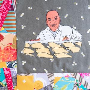 Lowell Hawthorne smiling in front of a tray of food.