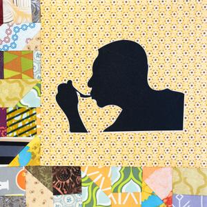 A silhouette of a man eating from a spoon.