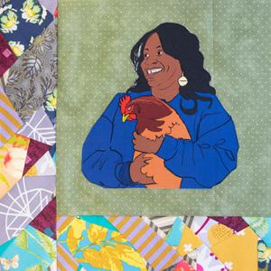 Yonnette Fleming smilng and holding a chicken.