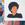 An African American person with an afro in a black shirt.