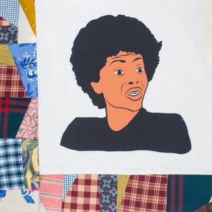 An African American person with an afro in a black shirt.