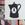 A black coffee poat with a woman's face.