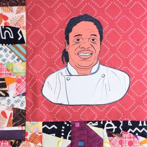 Matthew Raiford smiling in a white chef coat.