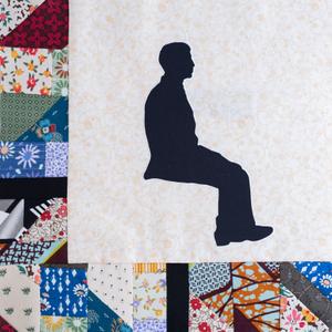 A silohuette of Frank Brown sitting.