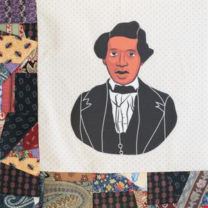 Tunis Campbell in a black suit.
